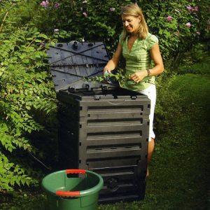 Woman adding material to composter Tierra Garden 79-Gallon Composter